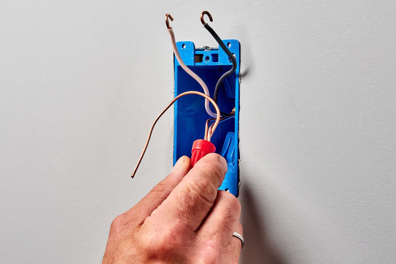 Grounding pigtail and grounding circuit wires enclosed in an orange cap.