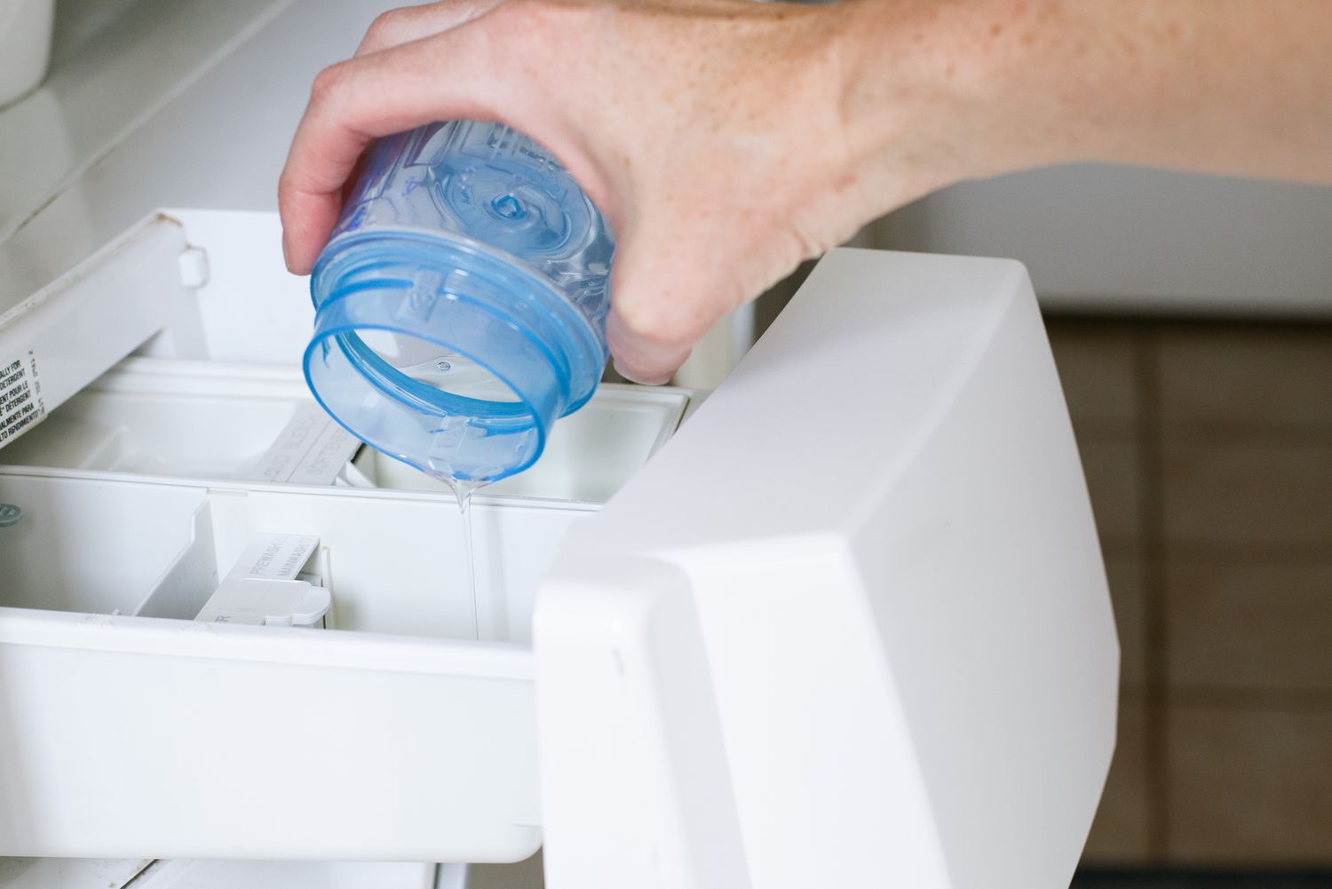 Detergent for laundry poured into the washing machine.