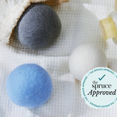 three dryer balls placed on a cotton throw