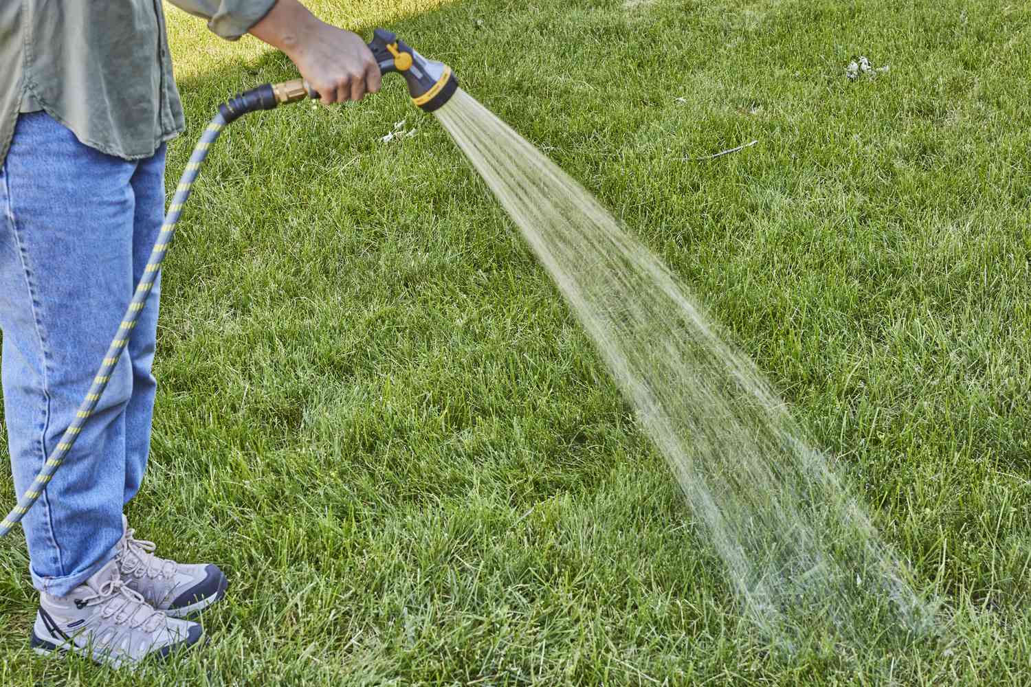 Moistening the grass prior to its removal.