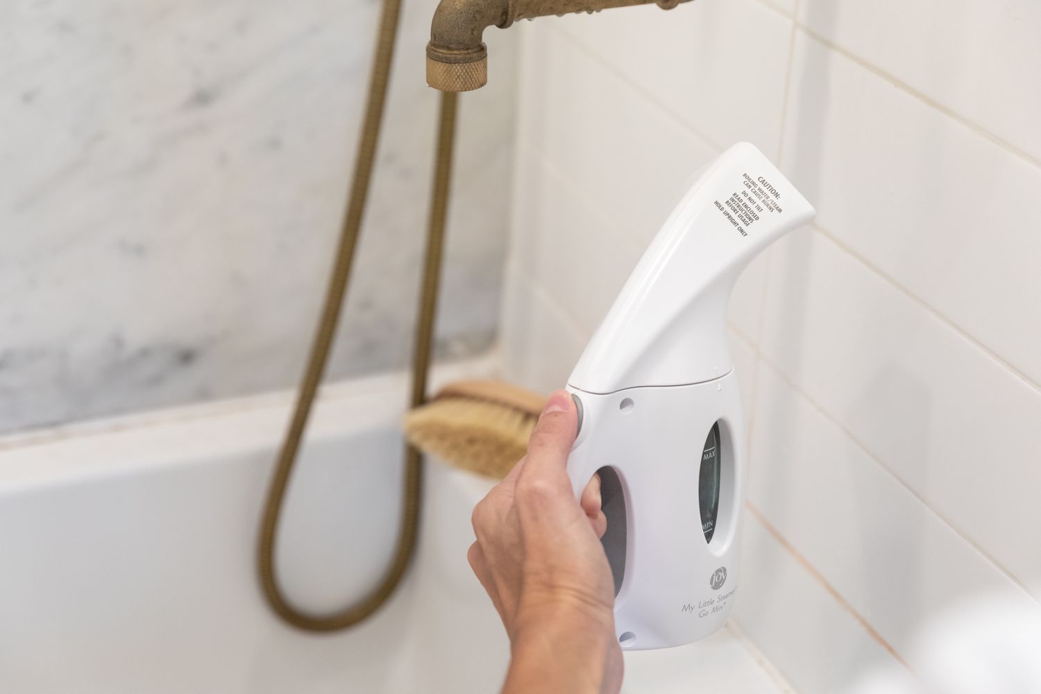 utilizing a steam cleaner on grout between tiles